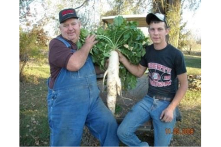 two men holding crop