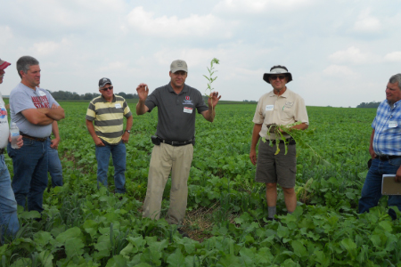 Jim Hoorman speaking to a group of farmers in a field