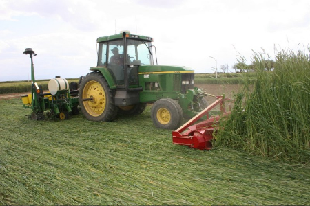 I & J crop roller crimper in front of tractor and planter 15 foot equipment